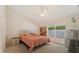 Comfortable bedroom with a king-size bed, ceiling fan, and large window at 607 Marcus St # 27, Venice, FL 34285