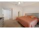 Spacious main bedroom with a king-size bed, ceiling fan, and walk-in closet at 607 Marcus St # 27, Venice, FL 34285