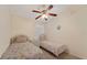 Guest bedroom with two twin beds, ceiling fan, and window with blinds at 607 Marcus St # 27, Venice, FL 34285