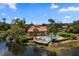 Aerial view of community pool area with a clubhouse and a lake view at 607 Marcus St # 27, Venice, FL 34285