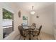 Compact dining area with a glass-top table and wicker chairs at 607 Marcus St # 27, Venice, FL 34285