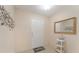 Welcoming entryway with neutral walls, white door, and decorative mirror at 607 Marcus St # 27, Venice, FL 34285