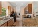 Modern kitchen featuring granite countertops, stainless steel appliances, and ample cabinet space at 607 Marcus St # 27, Venice, FL 34285