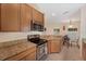 Well-equipped kitchen with granite countertops, stainless steel appliances, and a breakfast nook at 607 Marcus St # 27, Venice, FL 34285