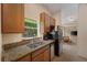 Bright kitchen with granite countertops, stainless steel appliances, and a window over the sink at 607 Marcus St # 27, Venice, FL 34285