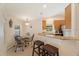 Eat-in kitchen with granite counters, wood cabinets, and stainless steel appliances at 607 Marcus St # 27, Venice, FL 34285
