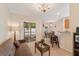 Open living and dining area with wicker furniture, breakfast bar, and sliding door to patio at 607 Marcus St # 27, Venice, FL 34285