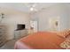 Inviting main bedroom featuring a king-size bed, ceiling fan, and ensuite bathroom at 607 Marcus St # 27, Venice, FL 34285