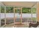 Relaxing screened-in porch with seating and views of the fenced backyard at 607 Marcus St # 27, Venice, FL 34285