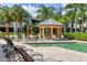 Resort-style pool with multiple lounge chairs and a shaded seating area at 6503 Moorings Point Cir # 202, Lakewood Ranch, FL 34202