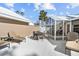 Private patio with lounge chairs and dining set at 698 Harrington Lake S Dr # 9, Venice, FL 34293