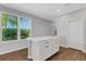 Kitchen island with white cabinets and quartz countertops, near a door at 8290 Velda Trl, Sarasota, FL 34241