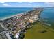 Aerial view showcasing waterfront homes and a beautiful coastline at 8855 Midnight Pass Rd, Sarasota, FL 34242