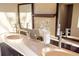 Elegant bathroom with double vanity and stone sinks at 8855 Midnight Pass Rd, Sarasota, FL 34242