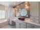 Bathroom with tile walls, round mirrors, and red vessel sink at 8855 Midnight Pass Rd, Sarasota, FL 34242