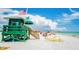 Lifeguard stand on a sunny beach with people swimming and relaxing at 8855 Midnight Pass Rd, Sarasota, FL 34242