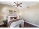 Bedroom with a king-size bed, ceiling fan, and hardwood floors at 8855 Midnight Pass Rd, Sarasota, FL 34242