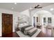 Large bedroom with wood floors, a ceiling fan, and access to a balcony at 8855 Midnight Pass Rd, Sarasota, FL 34242