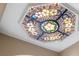 Close-up of an ornate, stained-glass ceiling fixture at 8855 Midnight Pass Rd, Sarasota, FL 34242