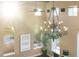 Ornate chandelier hanging from the high ceiling in a bright living room at 8855 Midnight Pass Rd, Sarasota, FL 34242