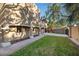 Side view of the house showcasing a large yard and paved walkway at 8855 Midnight Pass Rd, Sarasota, FL 34242