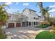 Two-story house with two-car garage and lush landscaping at 8855 Midnight Pass Rd, Sarasota, FL 34242