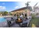 Outdoor fire pit with seating area next to the pool and covered patio at 8855 Midnight Pass Rd, Sarasota, FL 34242