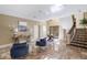 Spacious foyer with tiled flooring, stylish furniture, and a staircase at 8855 Midnight Pass Rd, Sarasota, FL 34242