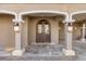 Elegant entryway with arched double doors and stone flooring at 8855 Midnight Pass Rd, Sarasota, FL 34242