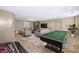 Game room featuring a pool table, arcade game, and comfortable seating area at 8855 Midnight Pass Rd, Sarasota, FL 34242