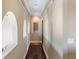 Long hallway with arched windows and dark wood flooring at 8855 Midnight Pass Rd, Sarasota, FL 34242