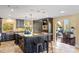 Open kitchen with large island, dark wood cabinets, and views to living room at 8855 Midnight Pass Rd, Sarasota, FL 34242