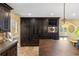 Kitchen with dark wood cabinetry, stainless steel appliances, and a built-in microwave at 8855 Midnight Pass Rd, Sarasota, FL 34242