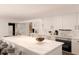 Bright white kitchen featuring a large island, modern appliances, and ample counter space at 8855 Midnight Pass Rd, Sarasota, FL 34242