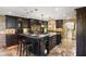 Spacious kitchen with large island, dark wood cabinets, and tile flooring at 8855 Midnight Pass Rd, Sarasota, FL 34242