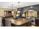 Elegant kitchen with dark wood cabinets, granite countertops and island at 8855 Midnight Pass Rd, Sarasota, FL 34242