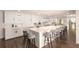 Modern white kitchen with large island, gold accents, and wood floors at 8855 Midnight Pass Rd, Sarasota, FL 34242