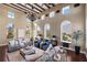 Sunlit living room featuring hardwood floors, exposed beams, and a cozy seating area at 8855 Midnight Pass Rd, Sarasota, FL 34242