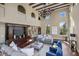 Living room with high ceilings, large windows, and comfortable seating at 8855 Midnight Pass Rd, Sarasota, FL 34242