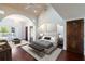 Main bedroom featuring vaulted ceilings, wood floors, and balcony access at 8855 Midnight Pass Rd, Sarasota, FL 34242