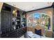 Office space with dark wood furniture and view of tropical landscaping at 8855 Midnight Pass Rd, Sarasota, FL 34242