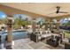 Covered patio with wicker furniture overlooking the pool at 8855 Midnight Pass Rd, Sarasota, FL 34242