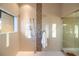 Large tiled shower with multiple fixtures and a window view at 8855 Midnight Pass Rd, Sarasota, FL 34242