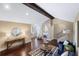 Sitting room with hardwood floors, a wood beam ceiling, and access to a bedroom at 8855 Midnight Pass Rd, Sarasota, FL 34242