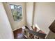 View of a staircase with decorative wrought iron railing and hardwood treads at 8855 Midnight Pass Rd, Sarasota, FL 34242