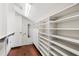 Spacious walk-in closet with built-in shelves, drawers, and ample storage space at 8855 Midnight Pass Rd, Sarasota, FL 34242