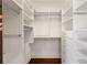 A walk-in closet featuring white shelves, drawers, and hanging rods at 8855 Midnight Pass Rd, Sarasota, FL 34242
