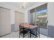 Small dining area with glass table and four chairs, near kitchen at 9611 Castle Point Dr # 912, Sarasota, FL 34238