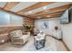 Cozy living room featuring wood beams, artwork, comfortable seating, and light wood floors at 105 Tucker Ave, Sarasota, FL 34232