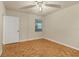 Empty bedroom with parquet flooring, white walls, and a ceiling fan at 1130 Villagio Cir # 203, Sarasota, FL 34237